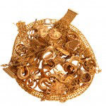 Pile of scrap gold scrap gold jewelry including gold rings, gold watches and gold chains